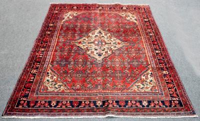 Appraisal: A Hamadan rug with central geometric medallion to a brick