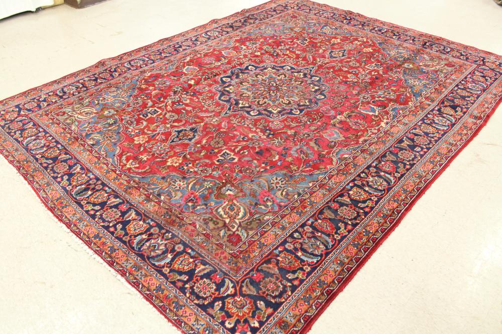 Appraisal: HAND KNOTTED PERSIAN CARPET floral and central floral medallion design