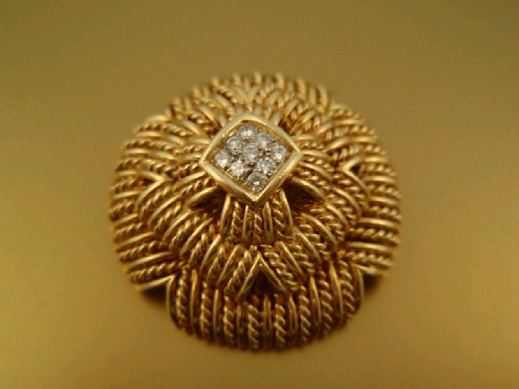 Appraisal: A circular tiered rope style brooch with nine small diamonds