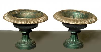 Appraisal: A PAIR OF VICTORIAN CAST IRON URNS of shallow lobed