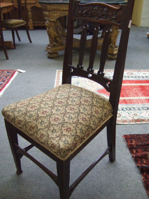 Appraisal: A set of three mahogany framed dining chairs of Art