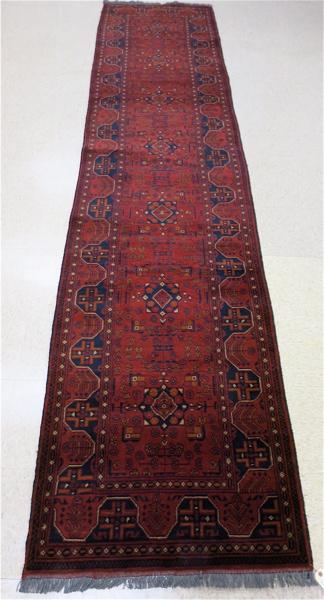 Appraisal: AFGHAN BELOUCHI TRIBAL RUNNER geometric repeating medallion and overall stylized