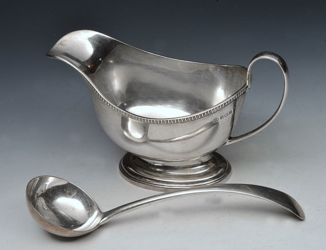 Appraisal: A SILVER SAUCE BOAT with gadrooned edge oval stepped foot