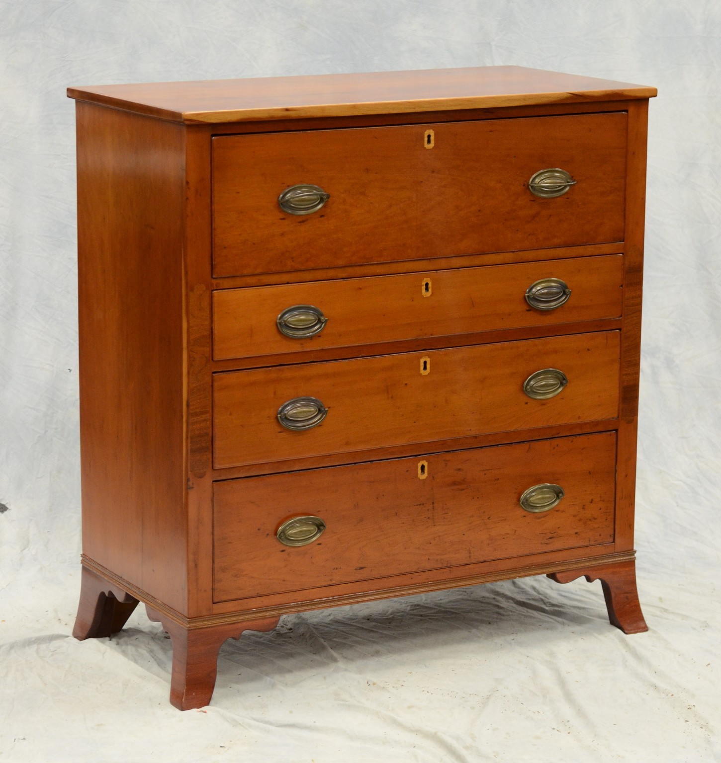 Appraisal: Cherry Hepplewhite reverse graduated four drawer chest flared foot wide