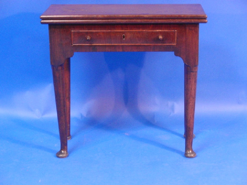 Appraisal: A George II mahogany tea table with rectangular folding top