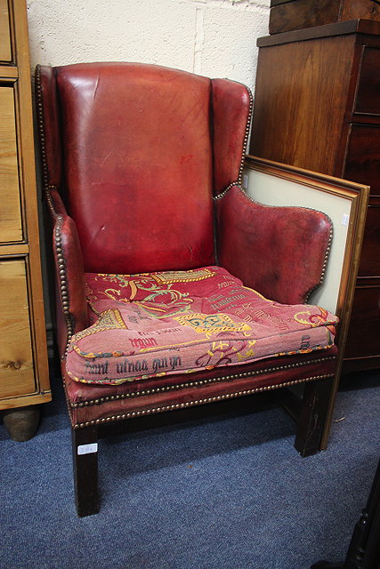 Appraisal: A TH CENTURY RED LEATHER UPHOLSTERED WING BACK OPEN ARMCHAIR