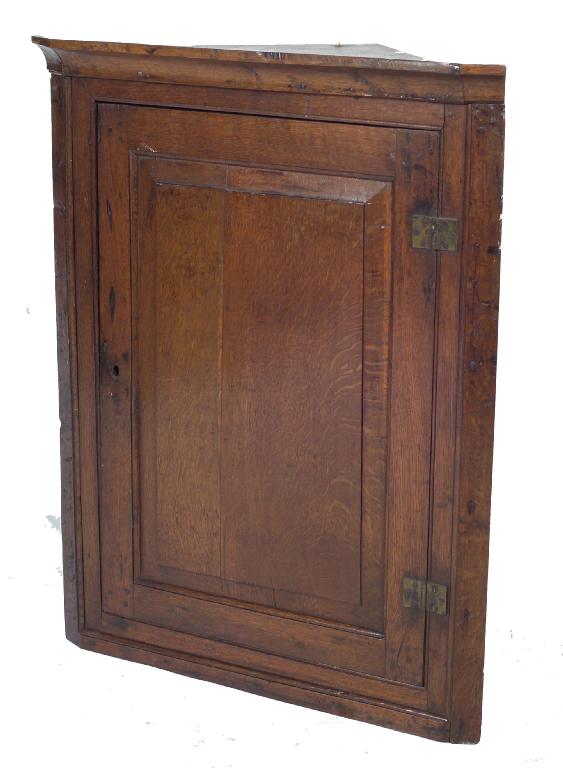 Appraisal: GEORGE III OAK HANGING CORNER CUPBOARD the projecting cornice above