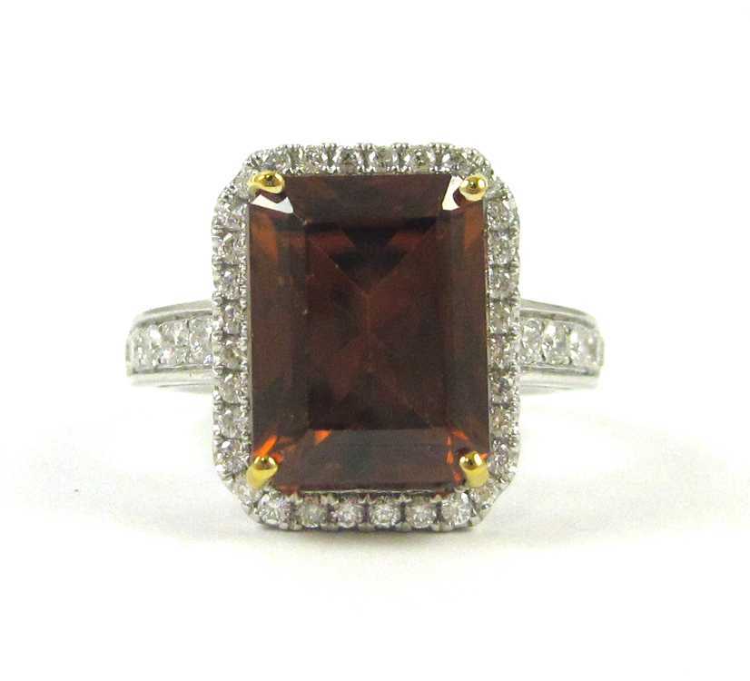 Appraisal: RED ORANGE ZIRCON AND DIAMOND RING The k white gold