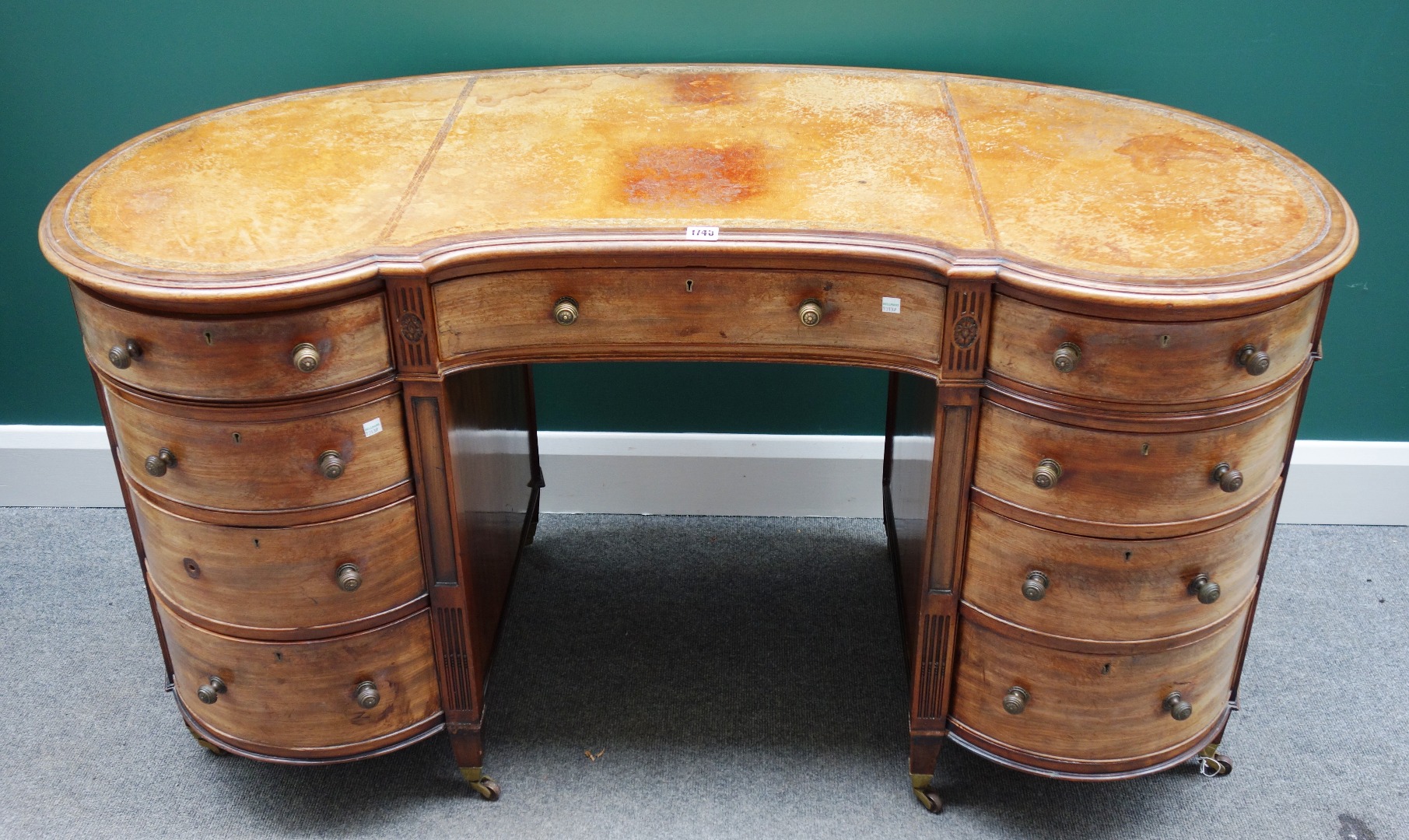 Appraisal: A th century mahogany kidney shaped desk the gilt tooled