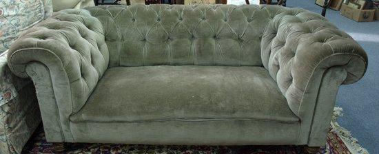 Appraisal: An upholstered deep buttoned back Chesterfield on turned legs cm