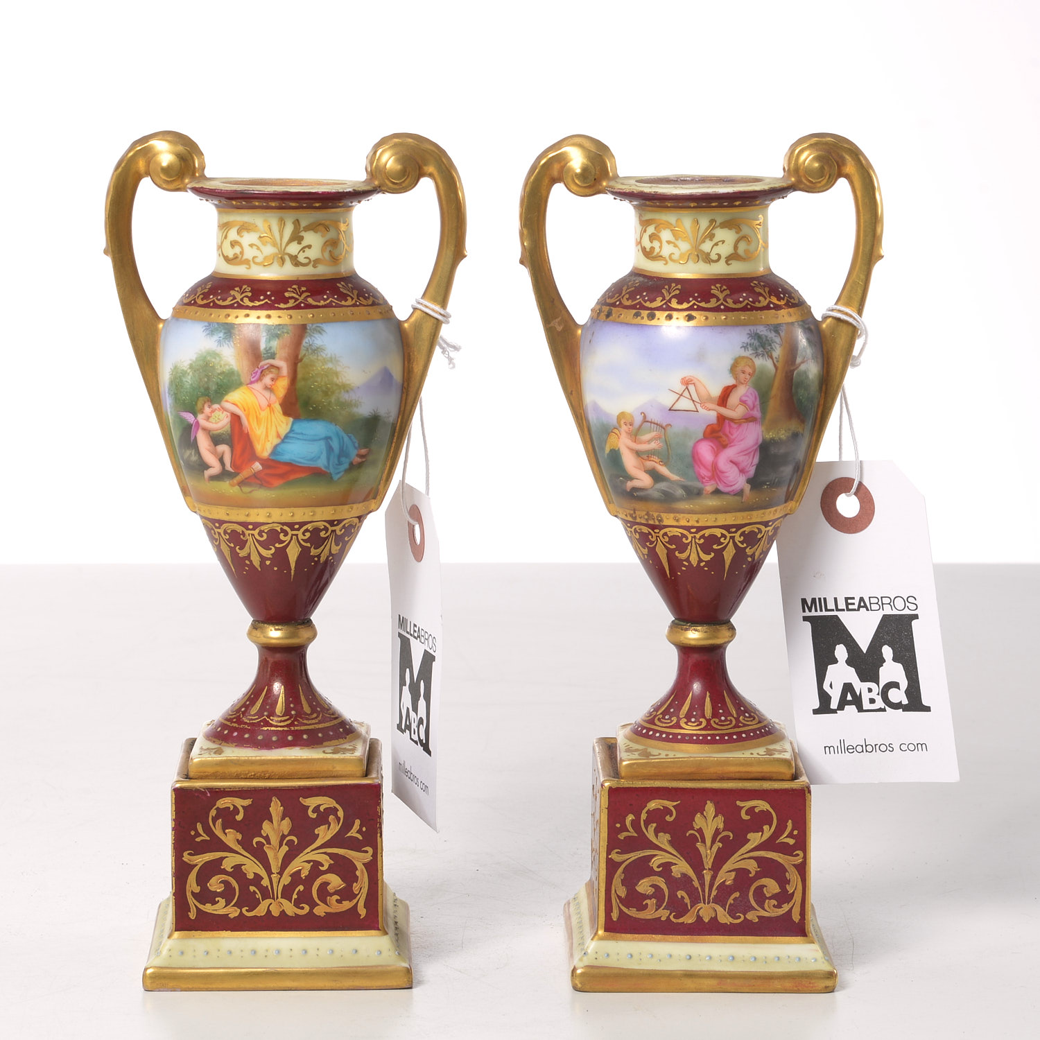 Appraisal: PAIR VIENNA STYLE HAND-PAINTED PORCELAIN URNS th th c miniature