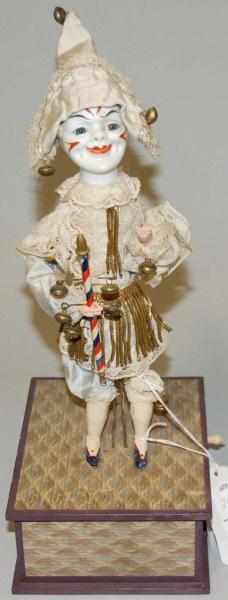 Appraisal: German Clown Automaton Music Box China face wooden arms and