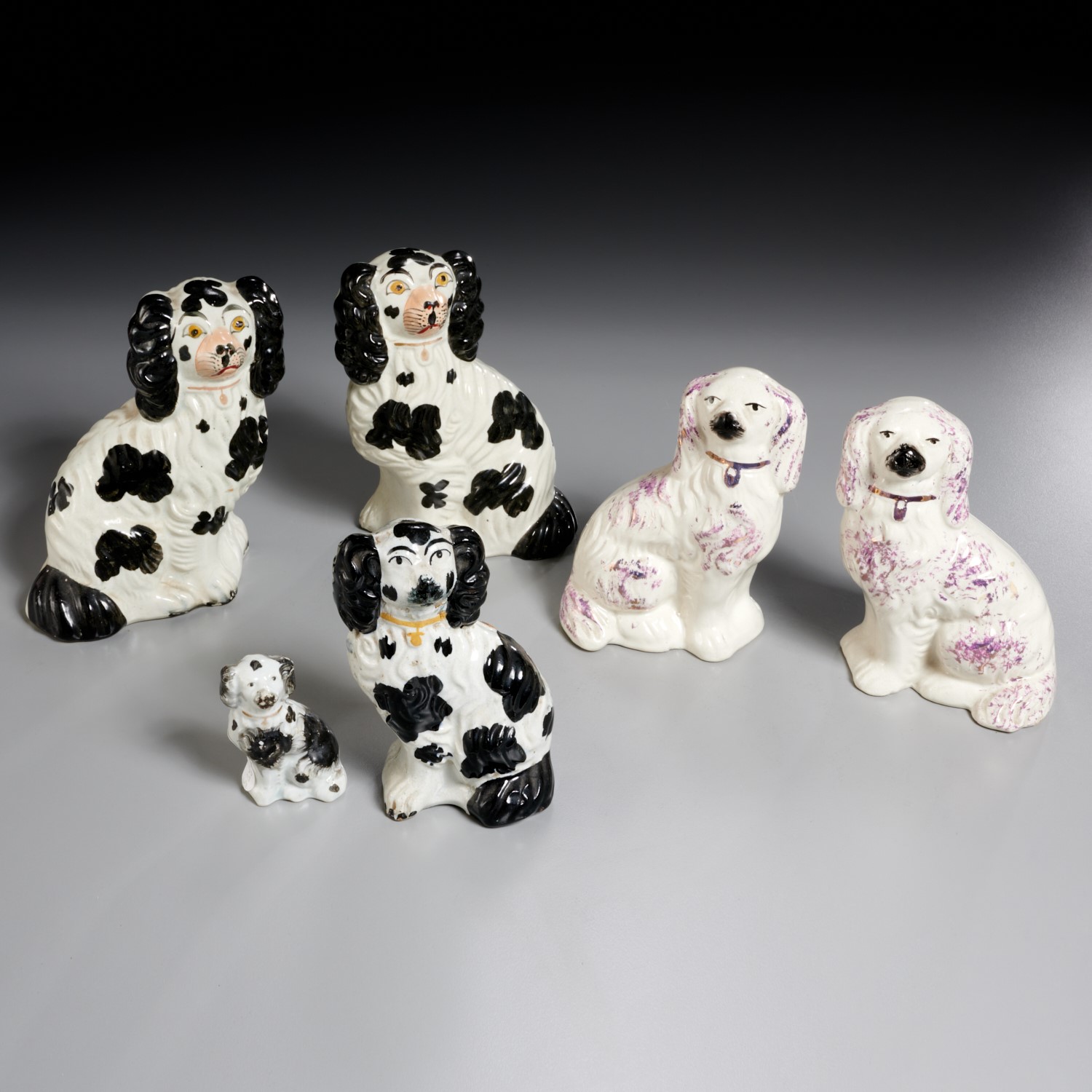 Appraisal: STAFFORDSHIRE DOGS th c including black and white spaniels and