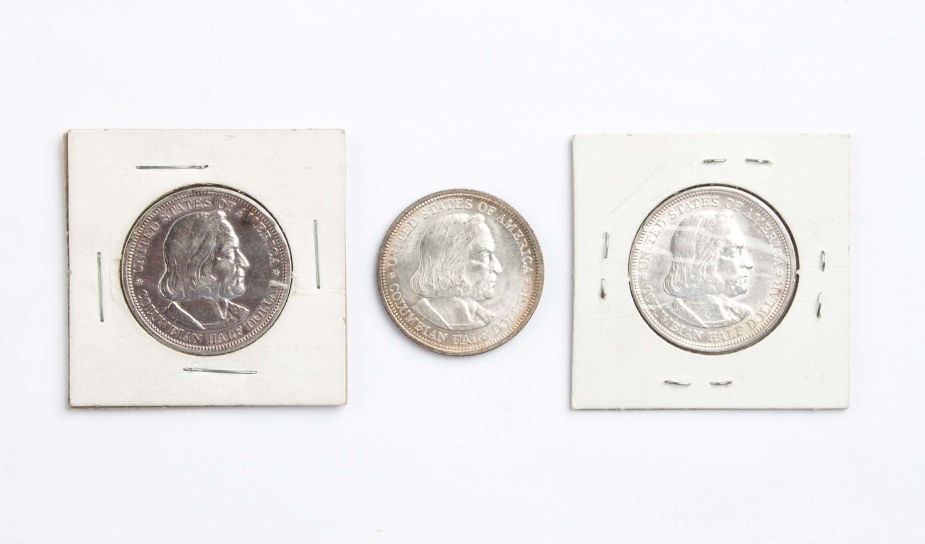 Appraisal: Three U S Columbian silver half dollars -' comprising MS-