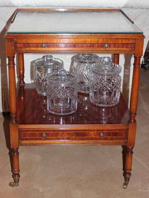 Appraisal: A PAIR OF MAHOGANY OCCASIONAL TABLES with cross banded tops