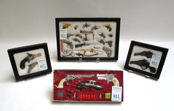 Appraisal: FOUR DISPLAYS OF MINIATURE AND TOY GUNS including The Outlaw