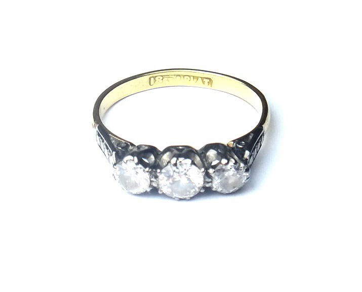 Appraisal: A gold and platinum diamond set three stone ring claw