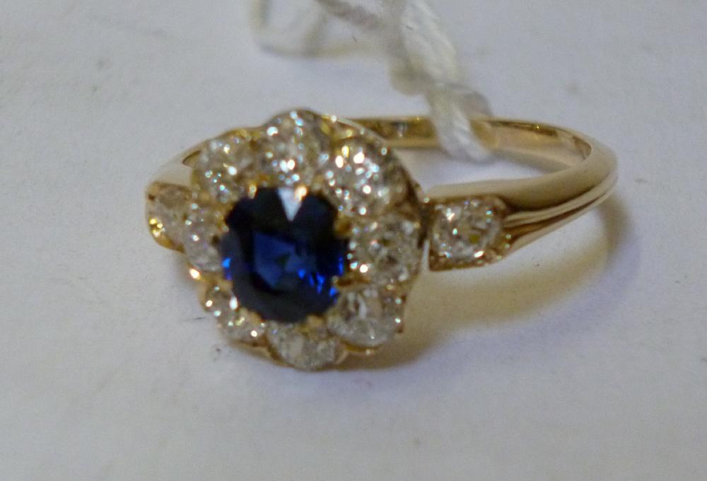 Appraisal: A SAPPHIRE AND DIAMOND CLUSTER RING the central round cut