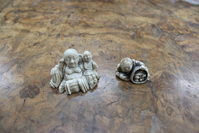 Appraisal: A LATE TH CENTURY JAPANESE IVORY NETSUKE of a seated