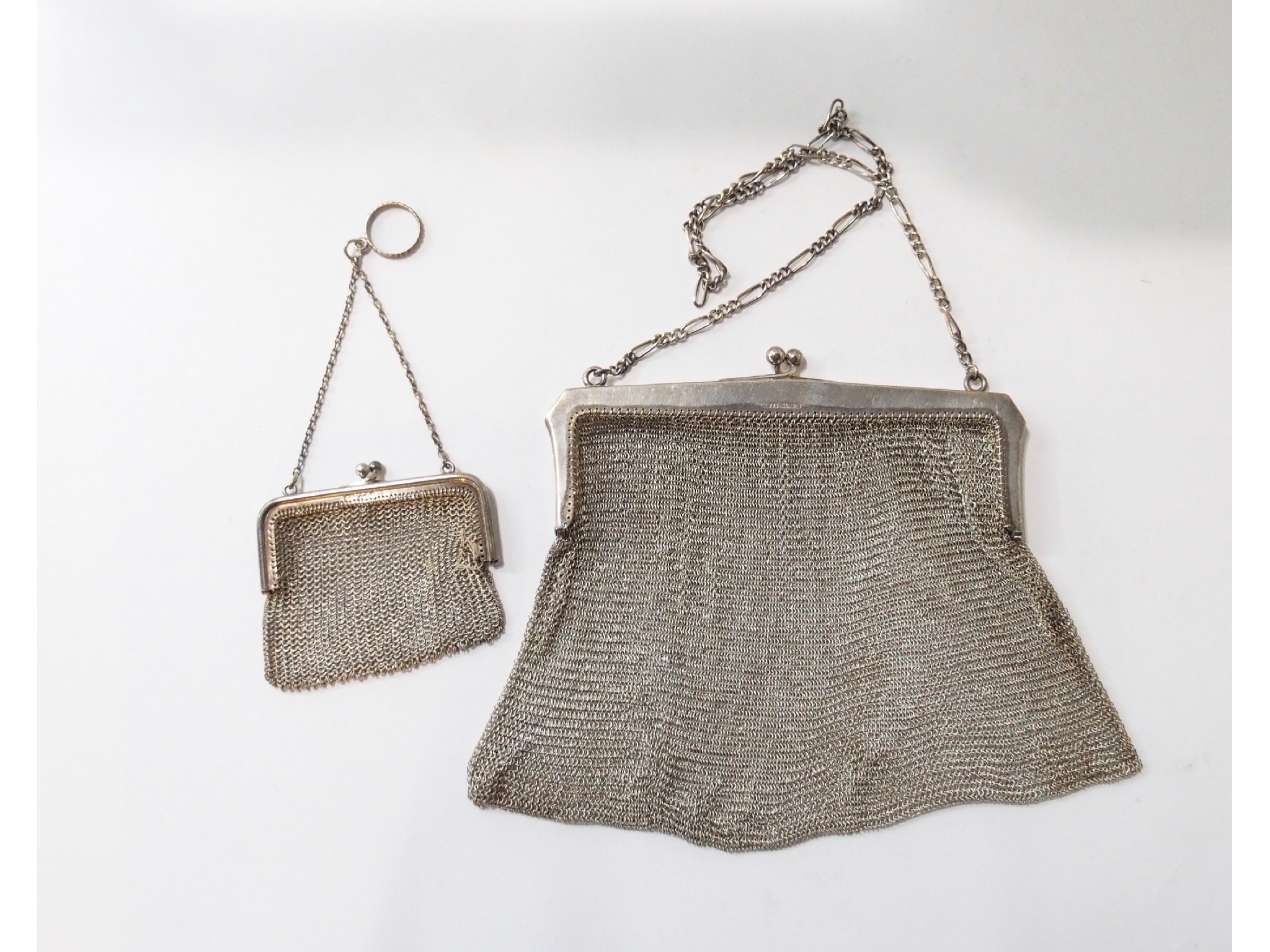 Appraisal: A continental silver mounted mesh purse with a small example