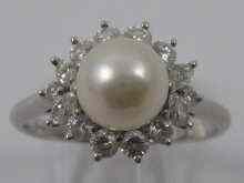 Appraisal: A platinum diamond and pearl ring by Tiffany Co The