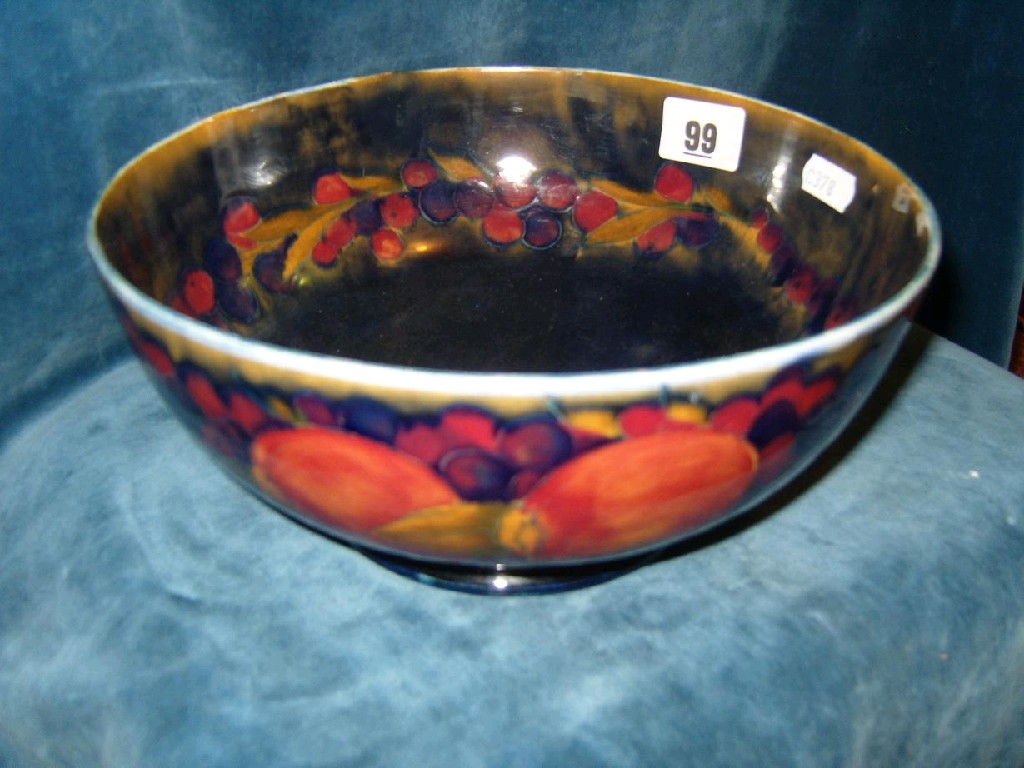 Appraisal: A Moorcroft fruit bowl with painted pomegranate and grape decoration