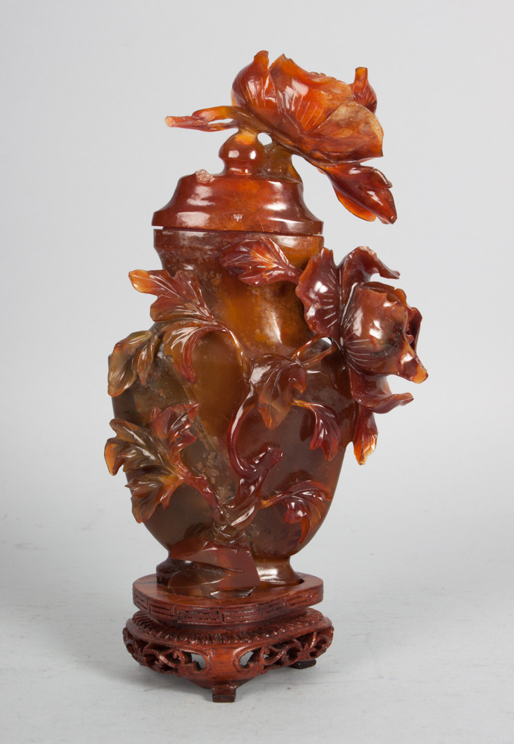 Appraisal: Chinese carved carnelian flower laden urn with wood stand in