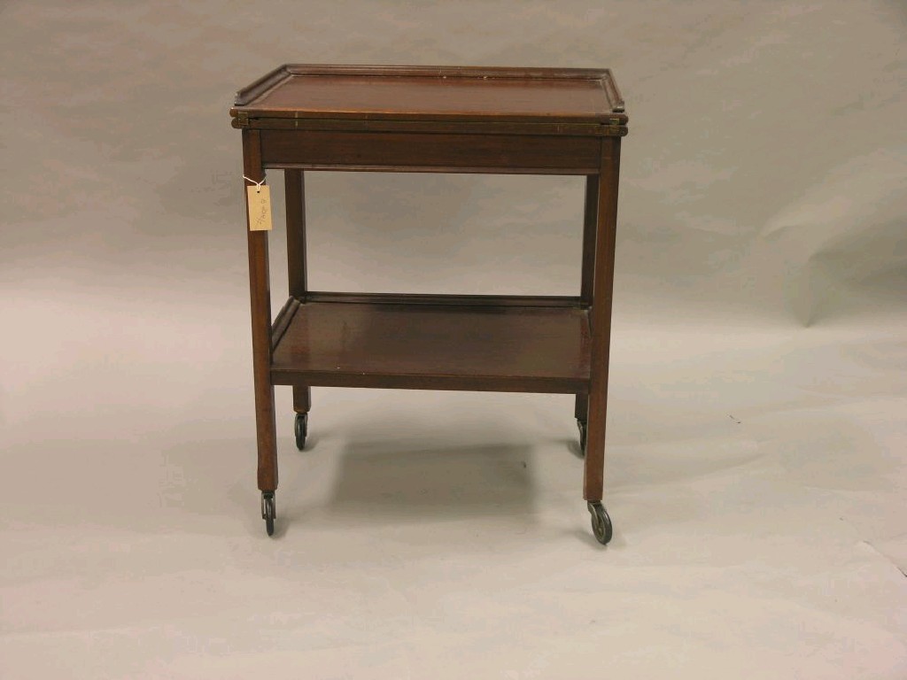 Appraisal: A walnut combination card table-trolley folding top with enclosed baize