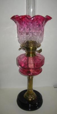 Appraisal: A VICTORIAN TABLE LAMP with brass reeded column cranberry reservoir