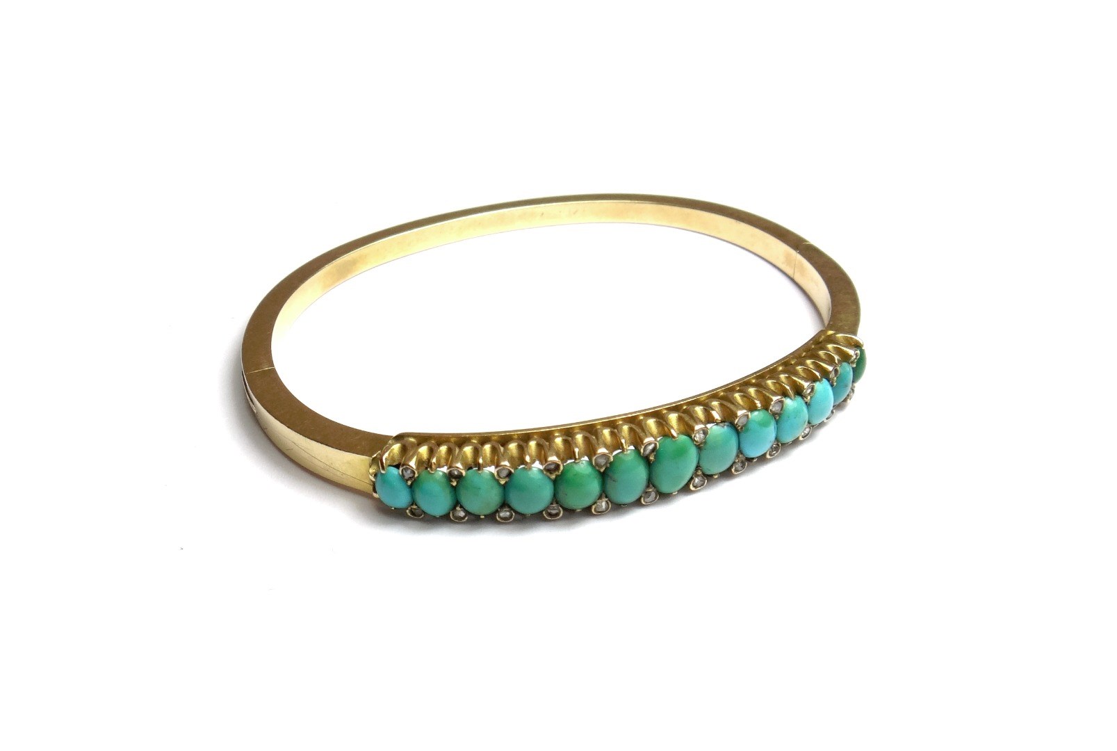 Appraisal: A turquoise set oval hinged bangle the front mounted with