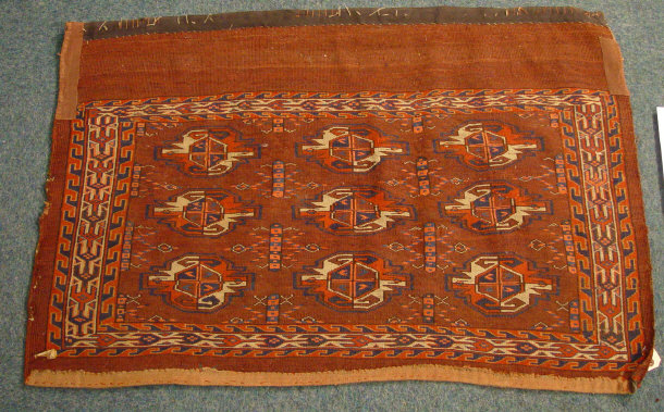 Appraisal: Rectangular brown ground mat decorated with a geometric blue and