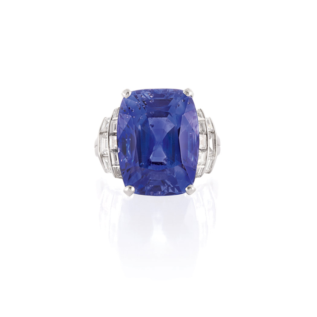 Appraisal: Platinum Sapphire and Diamond Ring Centering one brilliant-cut modified step-cut