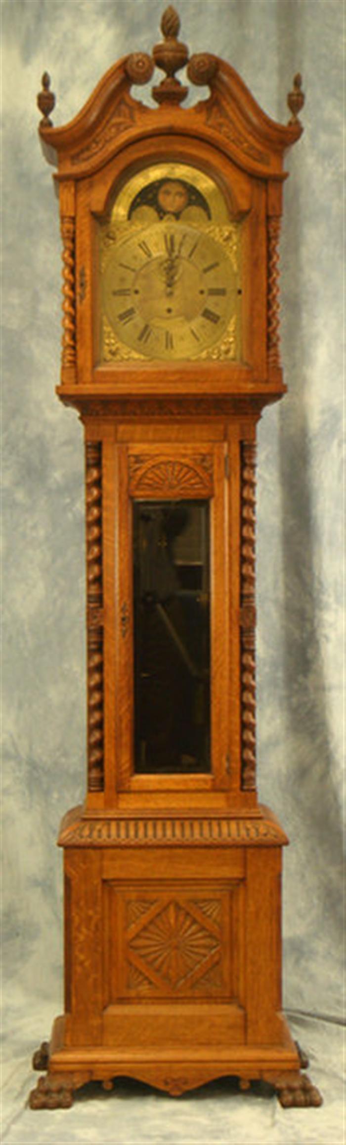 Appraisal: Carved oak tall case clock weight brass style movement with