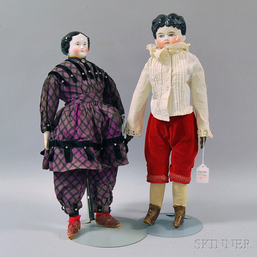 Appraisal: Two Black-haired China Head Dolls a boy doll with molded