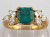 Appraisal: A yellow metal tests carat gold emerald and diamond ring