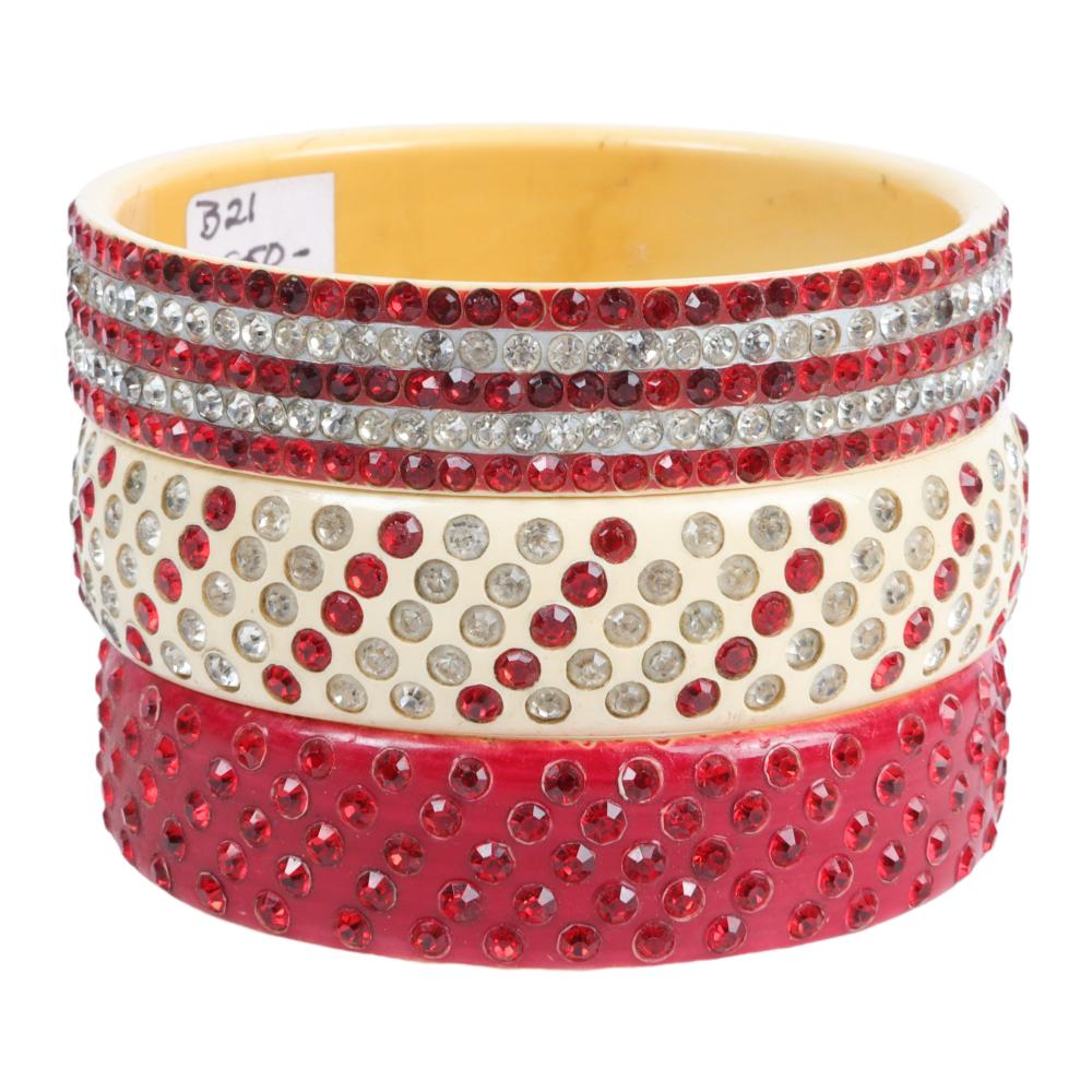 Appraisal: THREE RED ON CREAM CELLULOID SPARKLER BANGLE BRACELETS INNER WIDTH