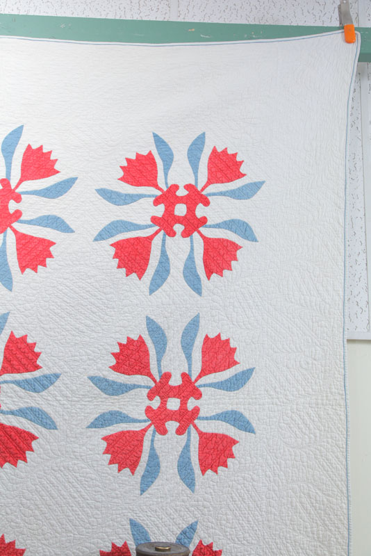 Appraisal: MID TH CENTURY APPLIQUE QUILT Red and blue floral pattern