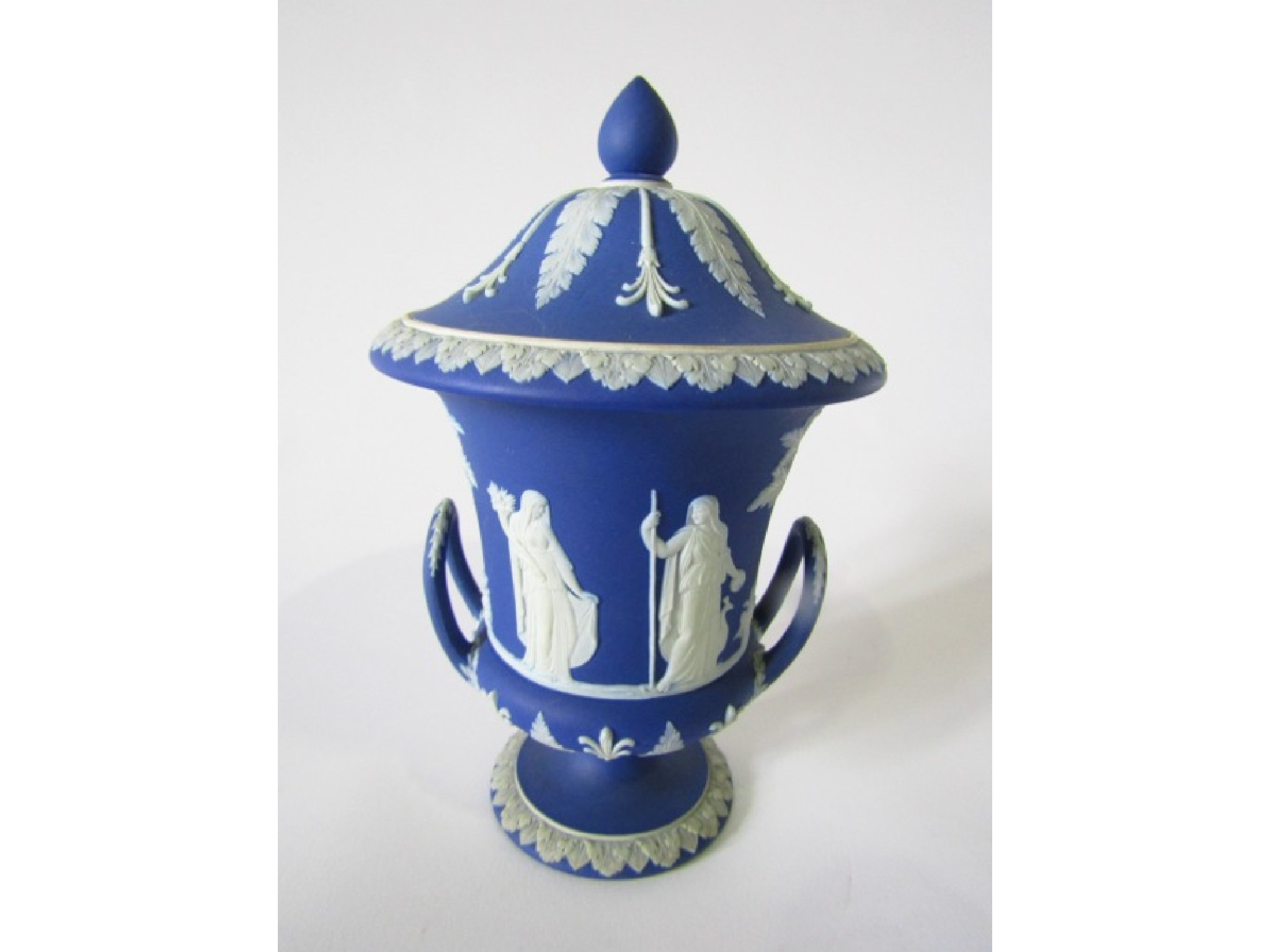 Appraisal: A th century Wedgwood blue ground jasperware two-handled urn-shaped vase