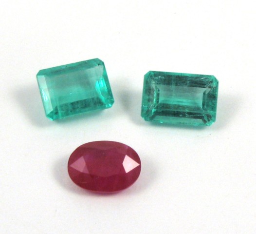 Appraisal: THREE UNSET GEMSTONES including an emerald-cut emerald weighing cts an