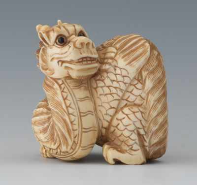 Appraisal: A Carved Ivory Netsuke of a Dragon Carved ivory depicting