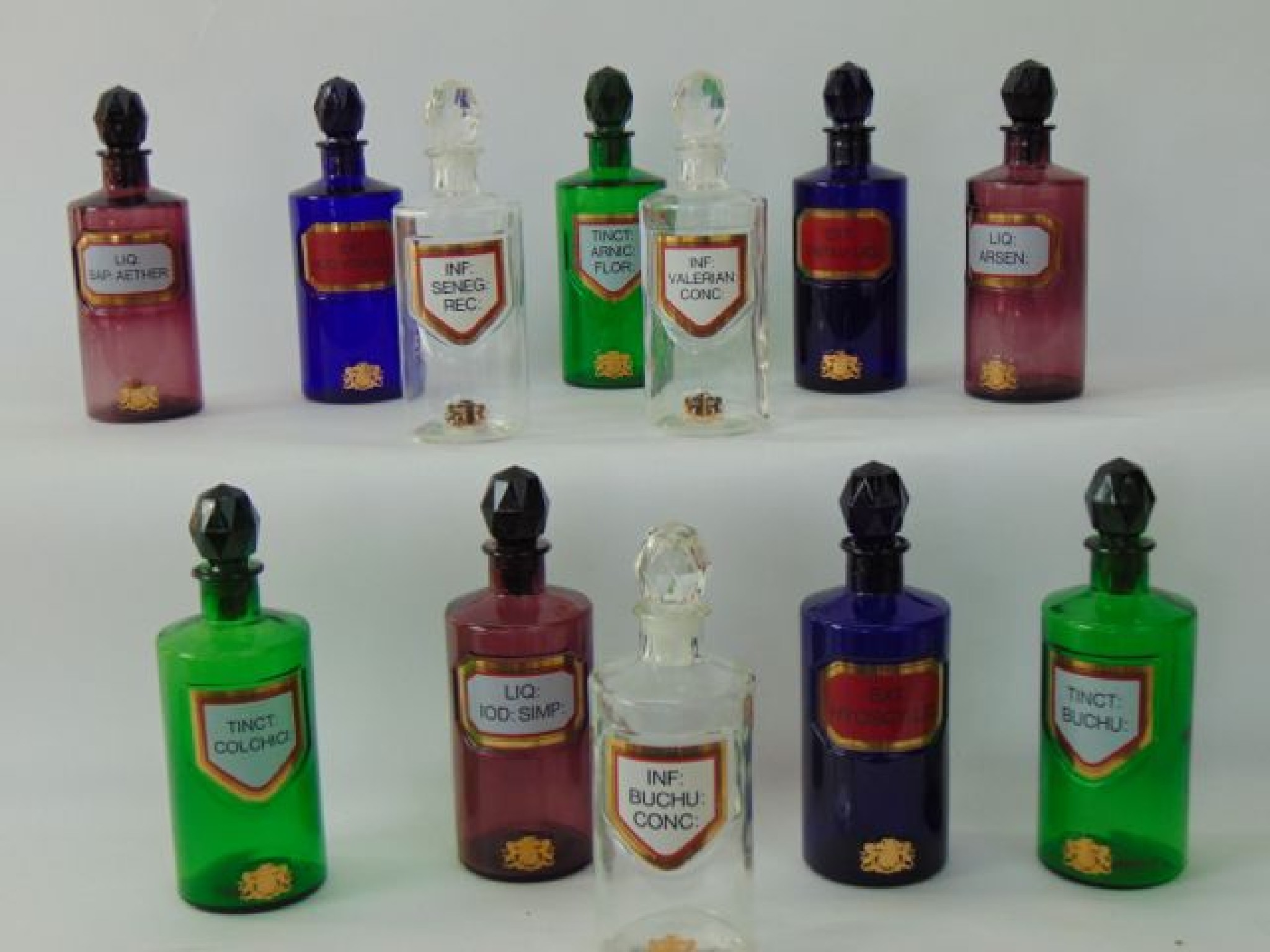 Appraisal: A collection of clear and coloured glass chemist bottles including