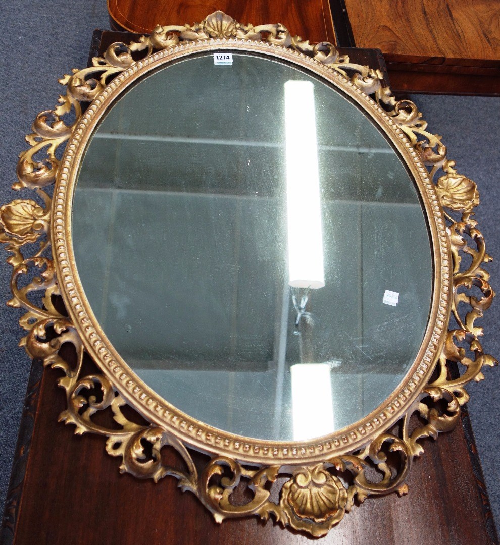 Appraisal: A th century oval gilt framed wall mirror with shell