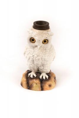 Appraisal: A German ceramic owl lamp base with glass eyes modelled