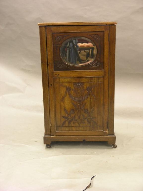 Appraisal: A Victorian walnut side cupboard enclosed by carved full length