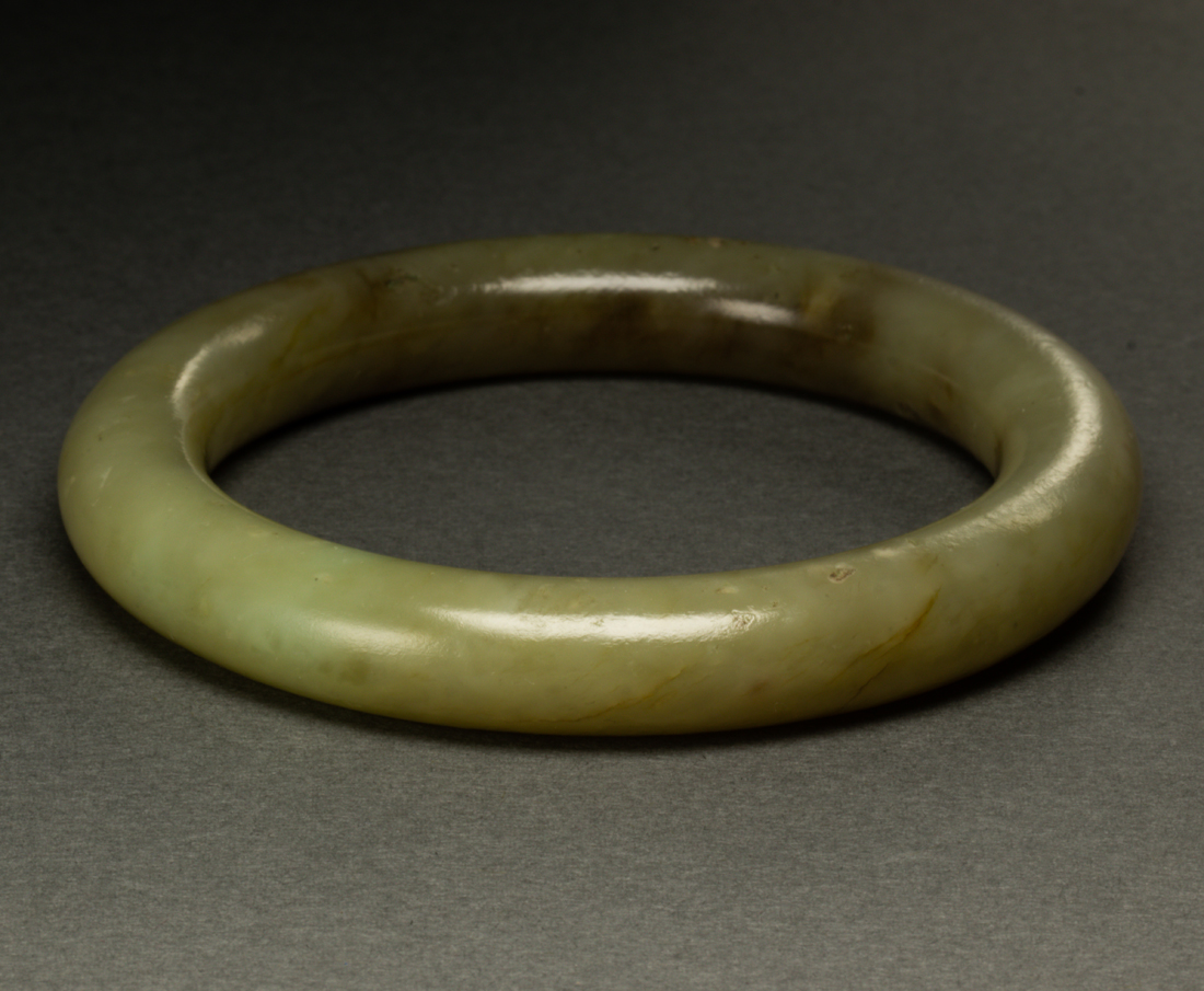 Appraisal: CHINESE CELADON JADE BANGLE Chinese celadon jade bangle inner diameter