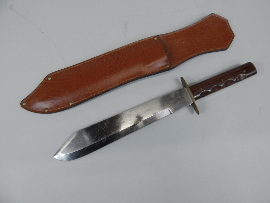 Appraisal: A thC machete with hardwood handle and leathered scabbard cm