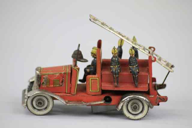 Appraisal: FIRE LADDER TRUCK PENNY TOY Germany elaborate tin lithographed ladder