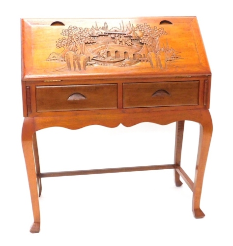 Appraisal: A thC Chinese carved bureau the fall heavily decorated with