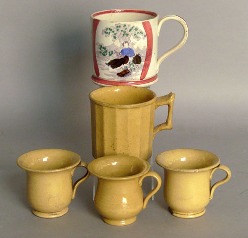 Appraisal: Four yelloware mugs together with a pearlware mug tallest -