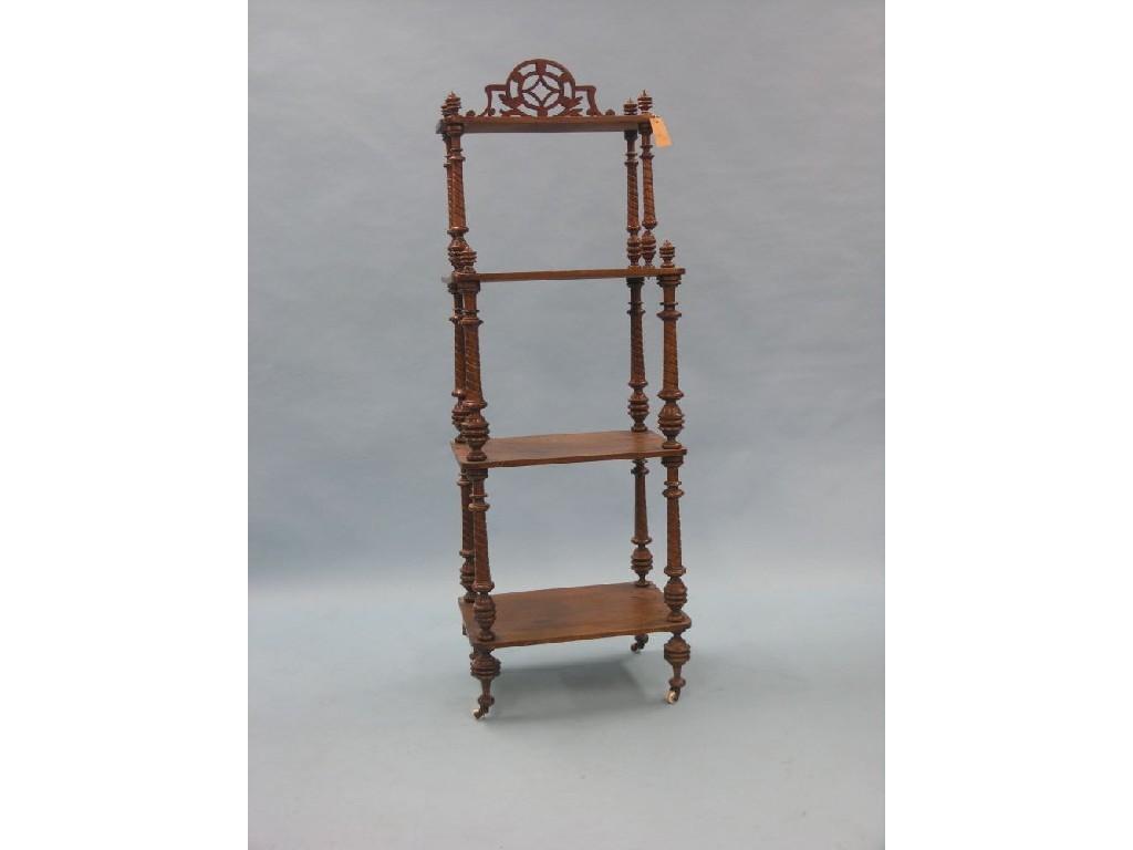 Appraisal: A Victorian walnut four-tier whatnot pierced cresting above spiral turned